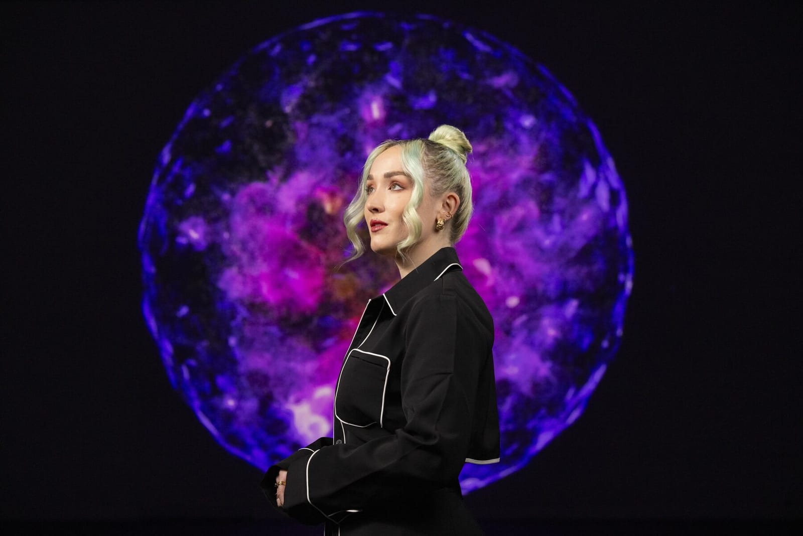 Claire Luxton in front of her immersive botanical work at Frameless, the largest permanent immersive art destination in London